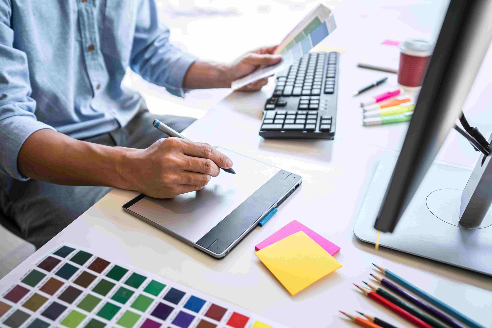 A designer working through brand colours at a studio desk