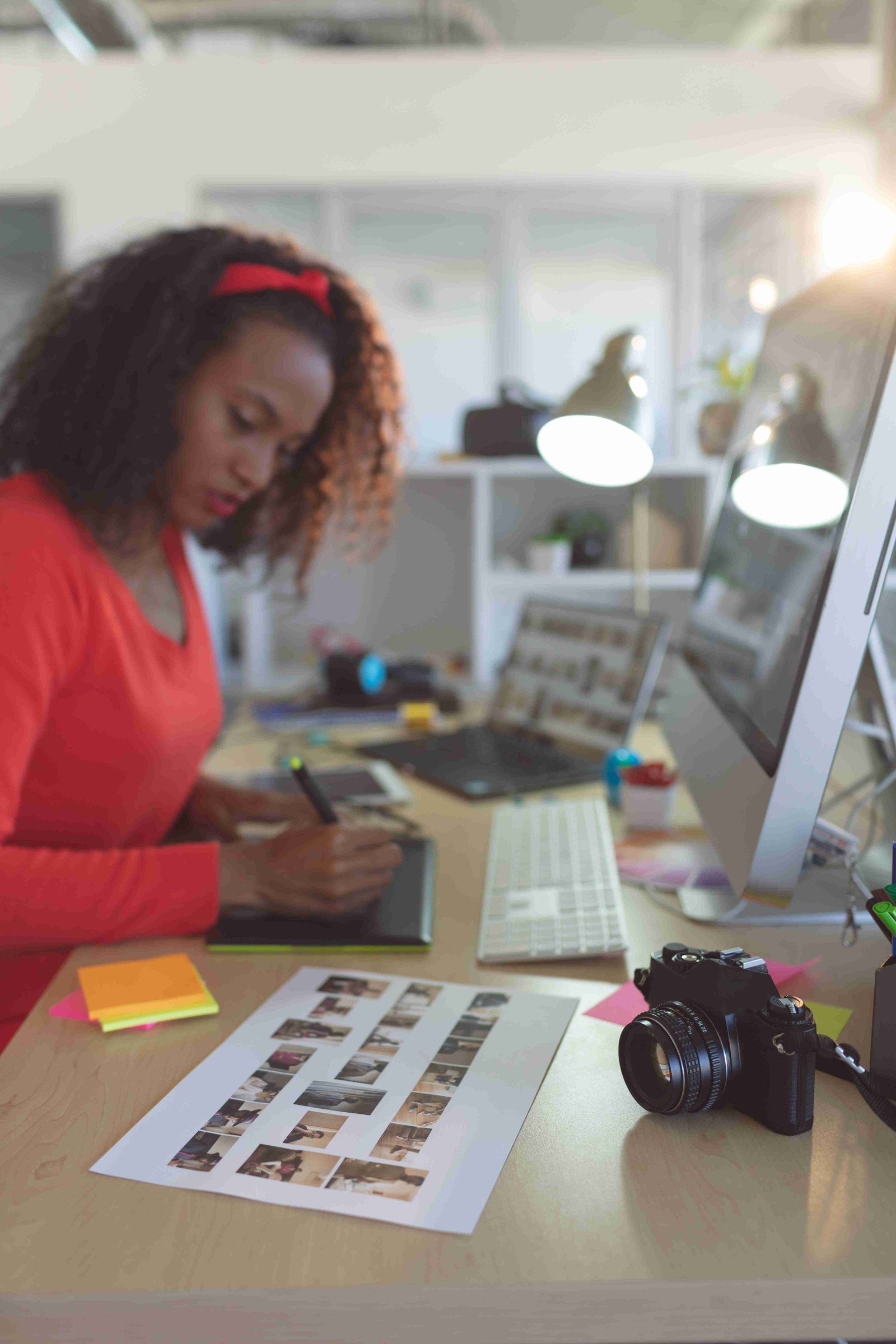 A photo editor grading images at a desk