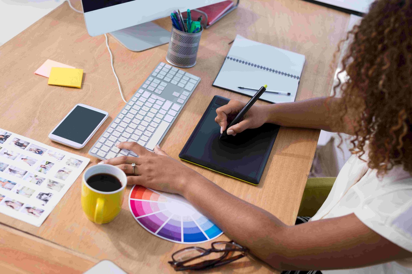 A graphic designer working at a desk